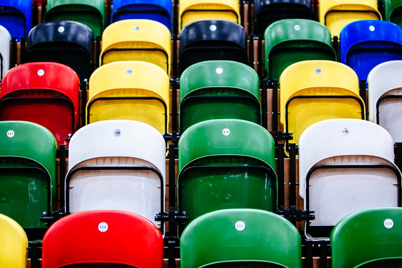 Colorful plastic seats arranged in rows, numbering visible.