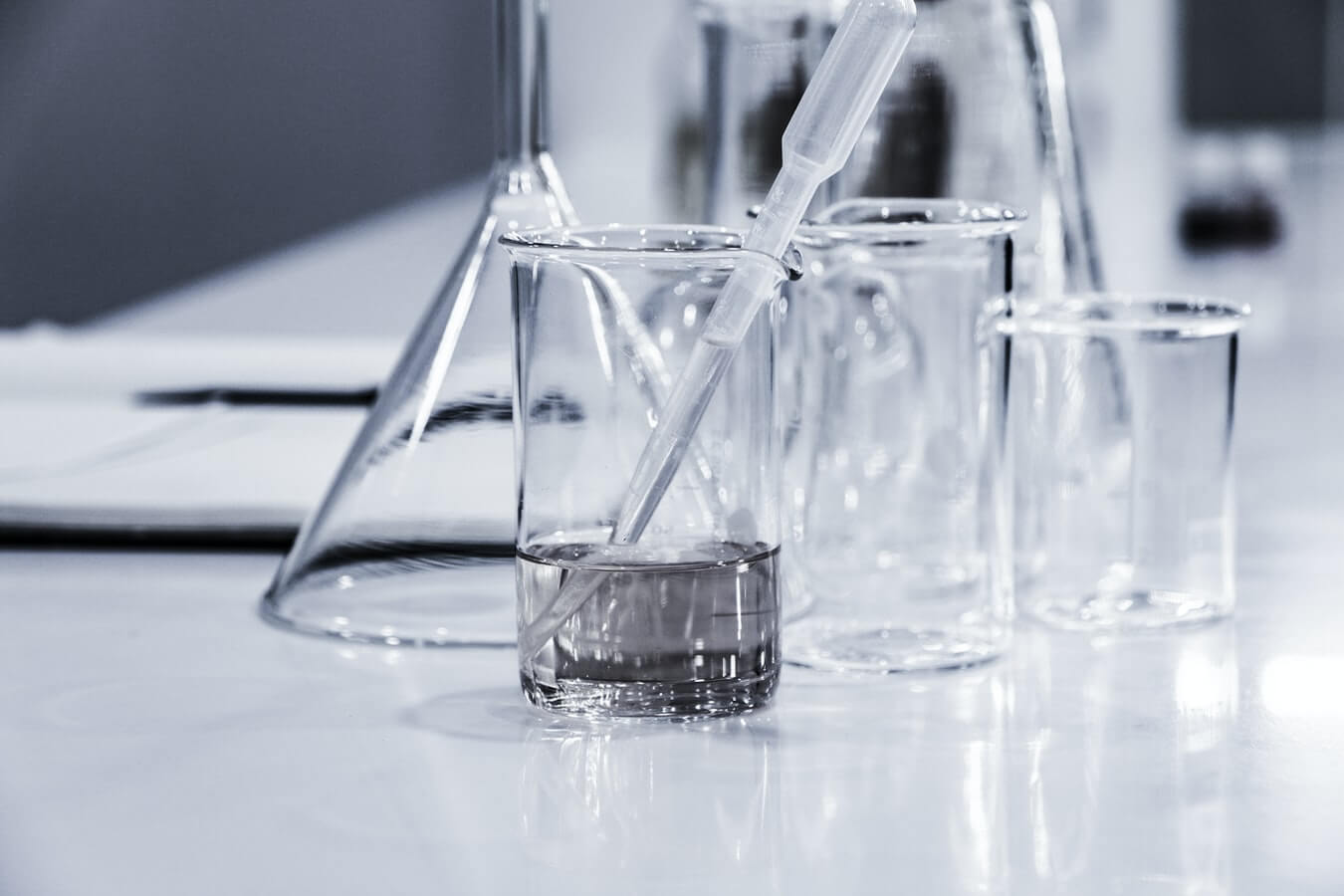 Pipette in beaker, resting on a laboratory countertop.