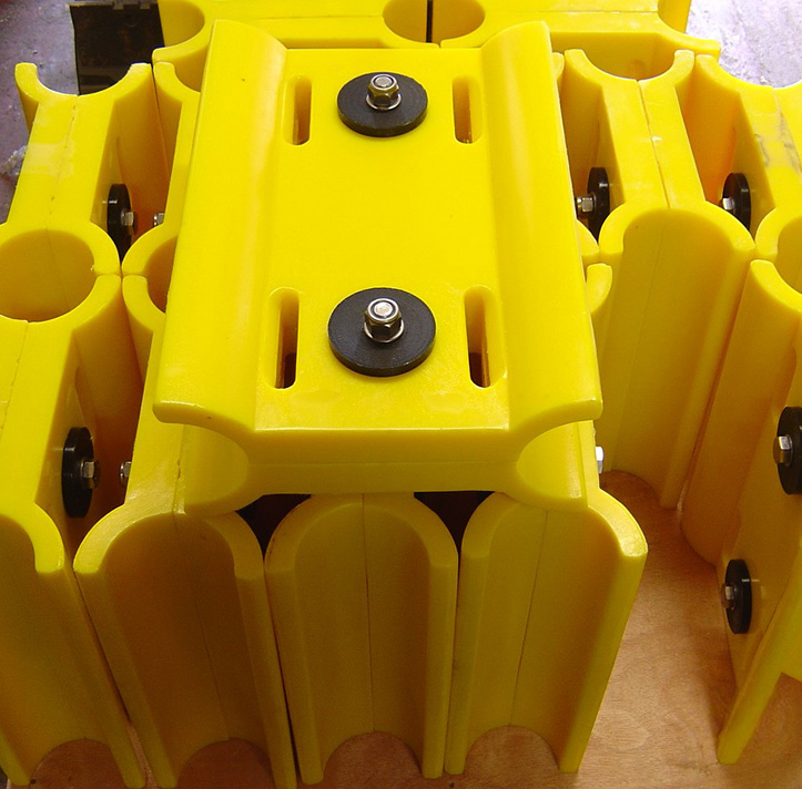 Yellow plastic casing stacked vertically with metal fasteners, indoors.