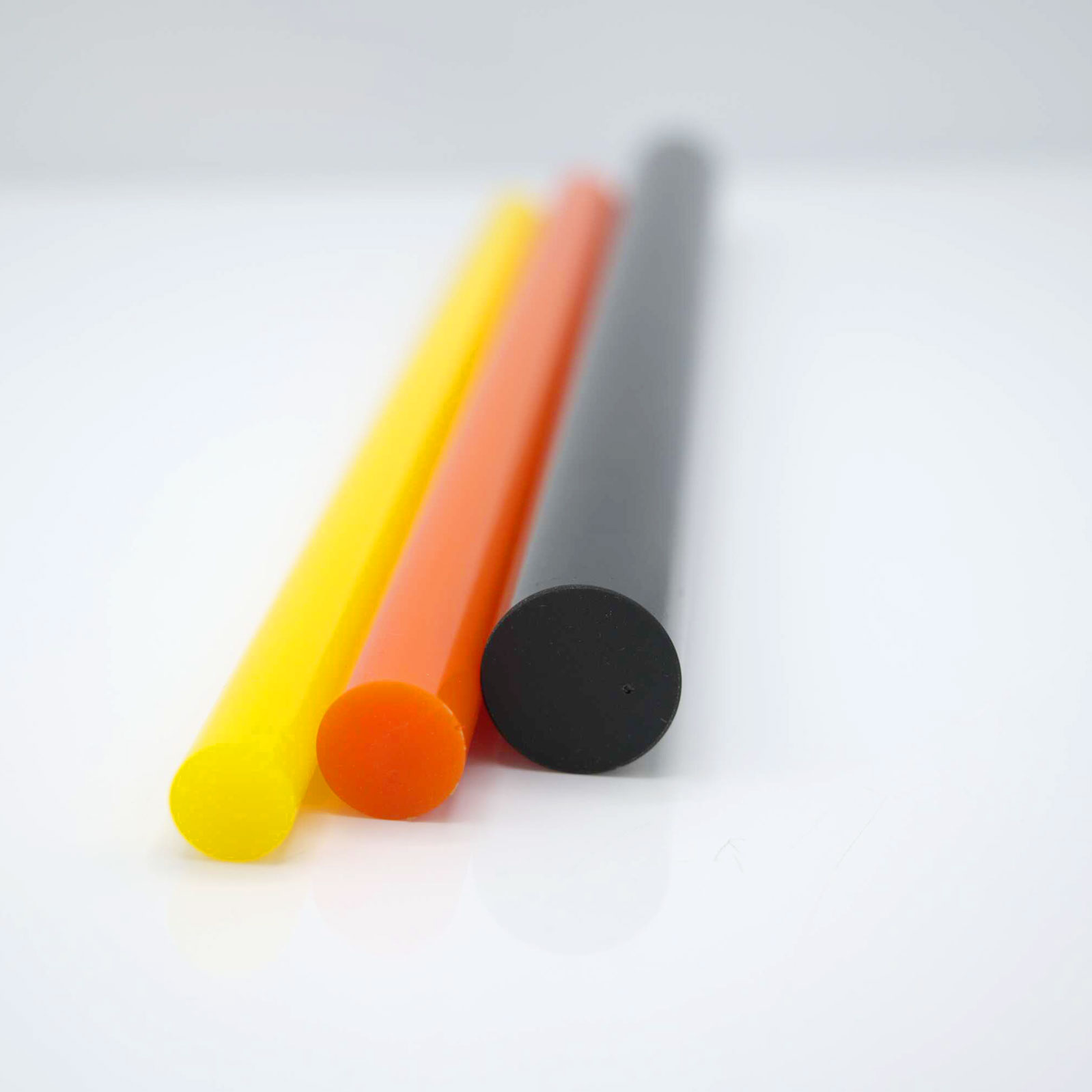 Colored rods lying parallel on white surface.