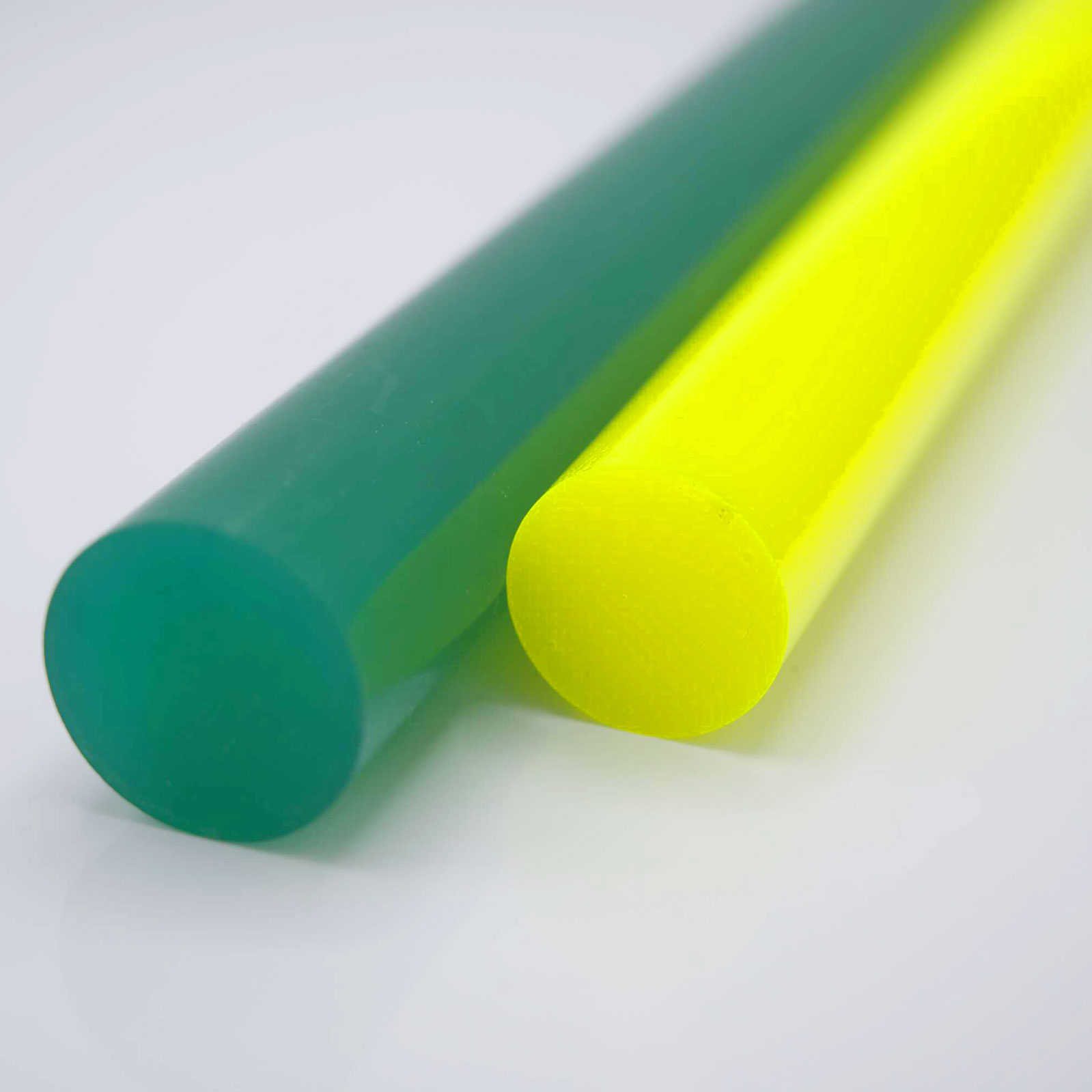 Green and yellow rods lying on a white surface.