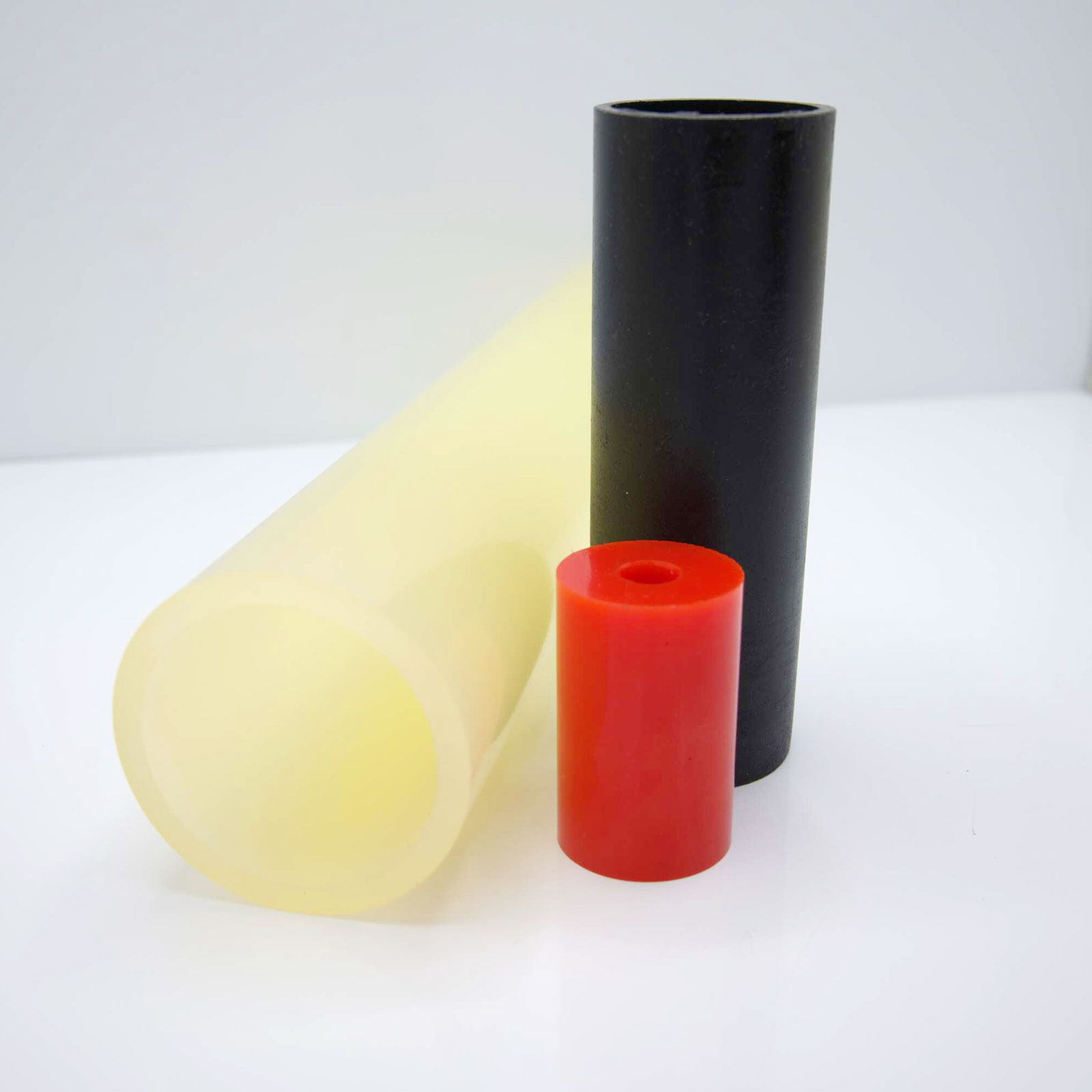 Cylinders standing, varying colors, on a plain surface.