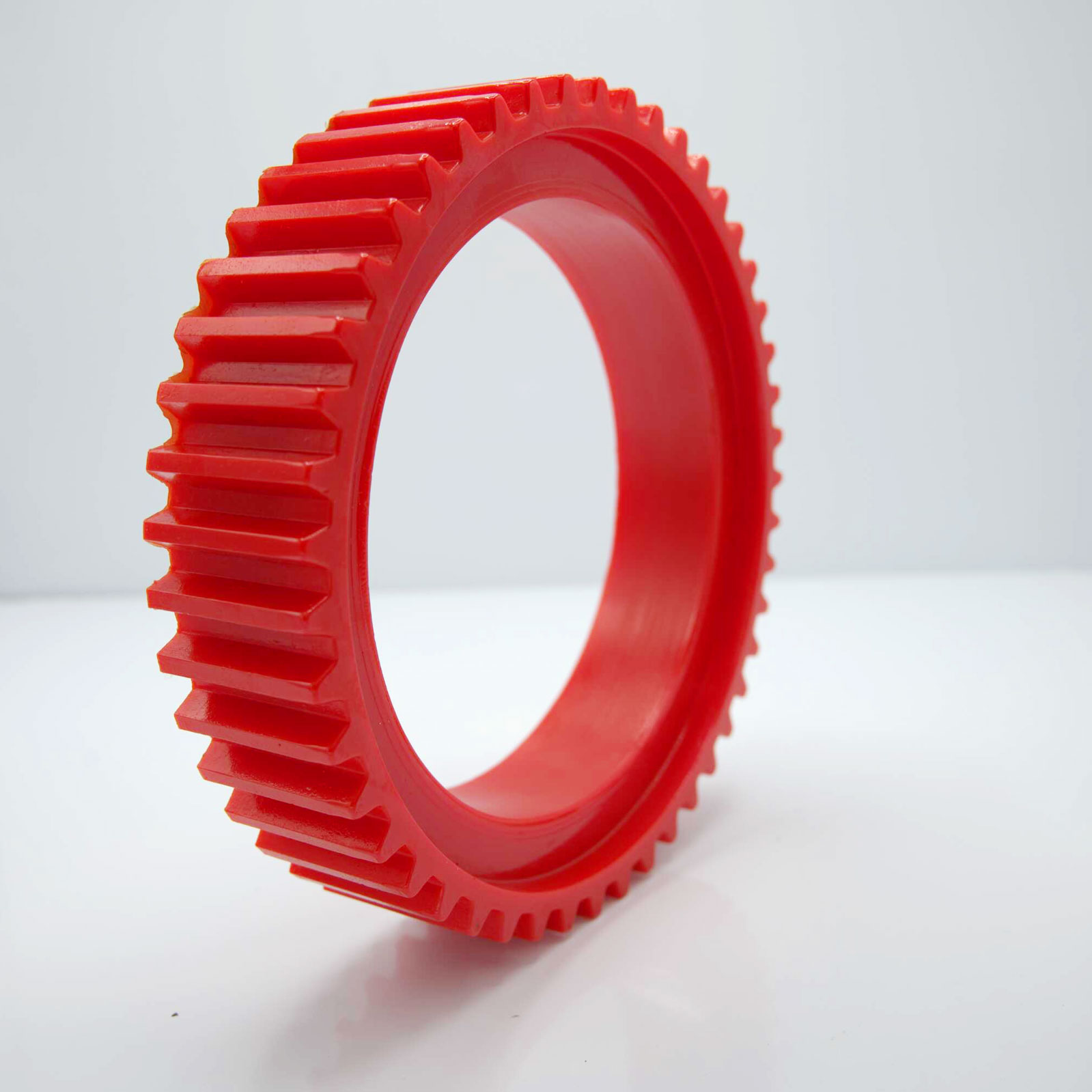 Red gear standing upright on a white surface.